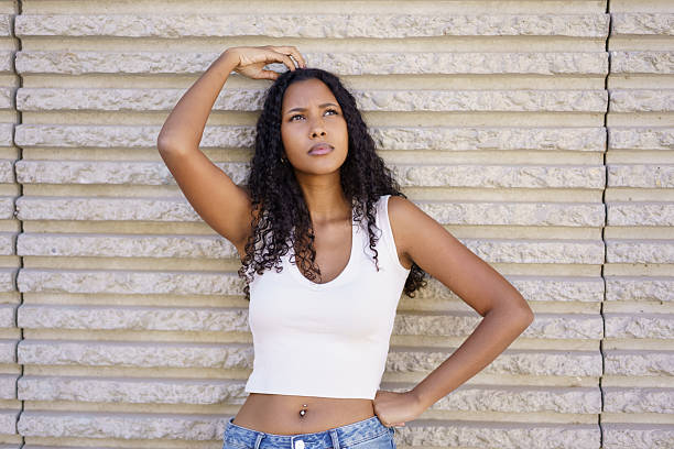 istock A Thoughtful Woman Posing Gracefully Against a Textured Wall, Exhibiting Elegance and Calmness 2212908848