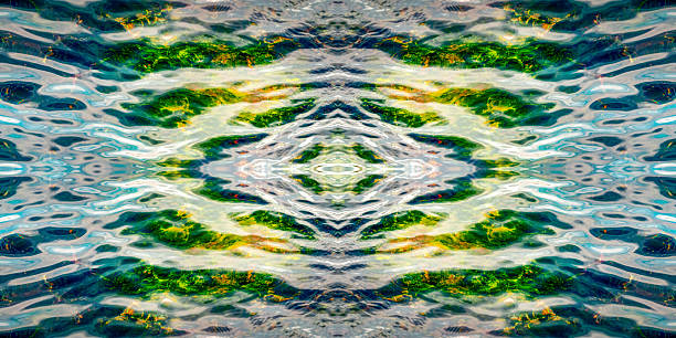 Whimsical glare and reflections, algae and stones under transparent water. symmetrical horizontally and vertically