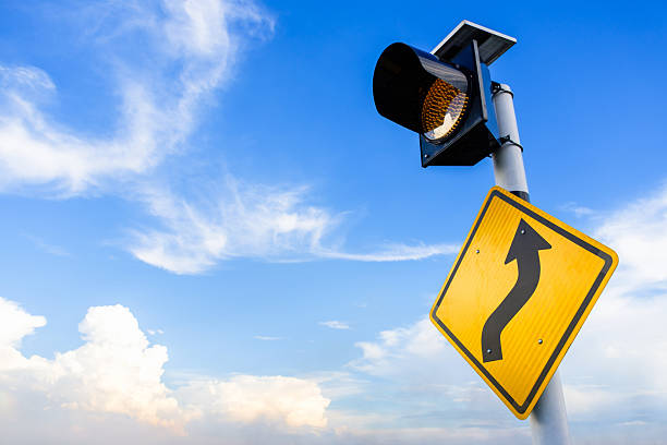 Curve ahead sign and flashing traffic lights