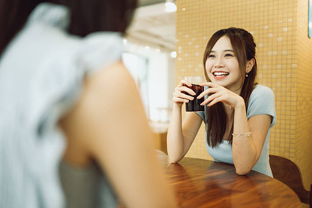 Young Asian woman gathering inside a cafe