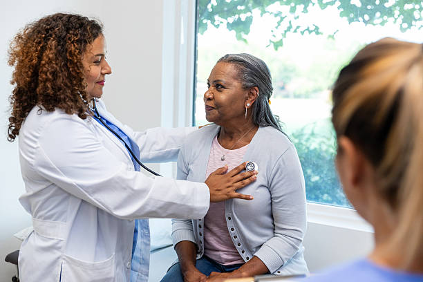istock Female Doctor Using Stethoscope on Patient During Checkup 2212912963