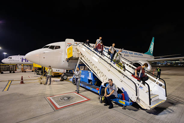 Hong Kong - April 19, 2025 : Passengers disembark from a Greater Bay Airlines Boeing 737-800 at Hong Kong International Airport.