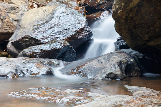 istock A stream of water flows between large rocks 2212914369