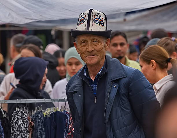 Bishkek, Kyrgyzstan. April 28, 2024. Portrait of an elderly Kyrgyz man in a national headdress (ak-kalpak) at the central city market.