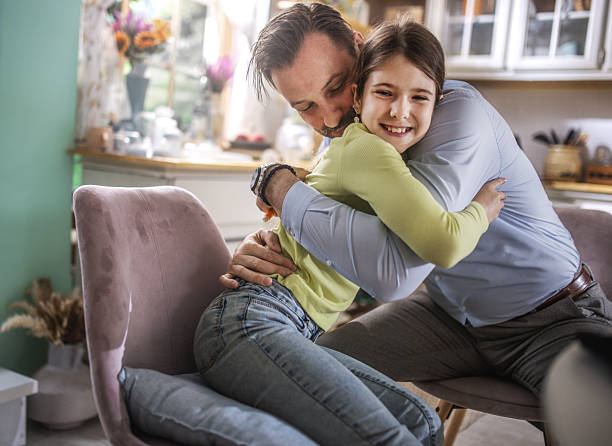 istock A father and his daughter cuddling at home 2212915598