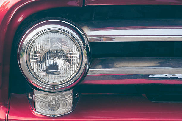 istock Closeup of old red car headlight.Classic Car Headlight. 2212917013