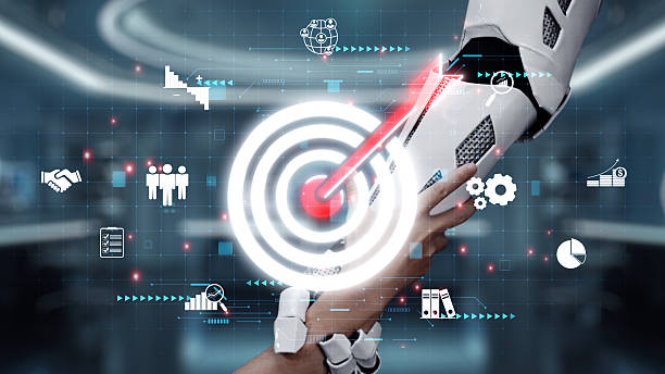 istock Futuristic robotic hand reaching out to connect with human hand, symbolizing collaboration and technology integration in a digital workspace environment. Auvana 2212917553