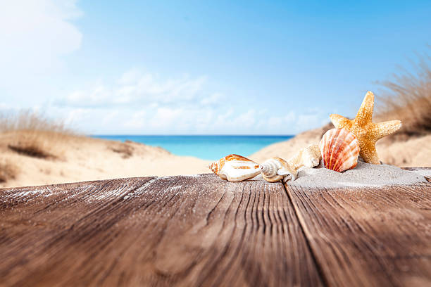 istock Wooden table with copy space with beach and sea and sky background. 2212917926