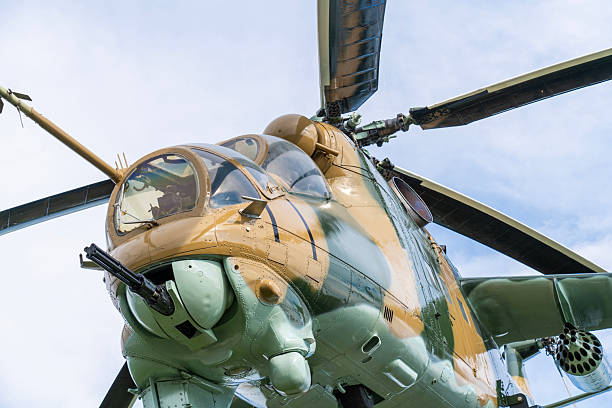 istock Camouflaged Soviet Mi-24 military attack helicopter in low flight 2212918367