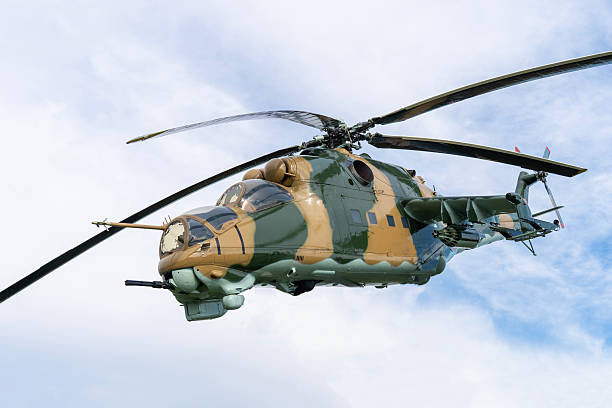 istock Camouflaged Soviet Mi-24 military attack helicopter in low flight 2212918379