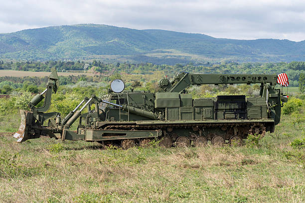 istock Green military engineering vehicle with crane and bulldozer blade 2212918404