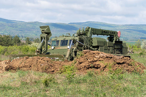 istock Green military engineering vehicle with crane and bulldozer blade 2212918406