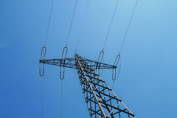 istock High-voltage power pylon in sunshine 2212919986