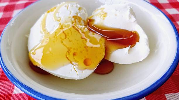 Honey poured on clotted cream. Honey clotted cream