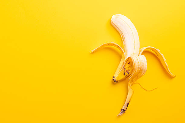 Banana half peeled lying down