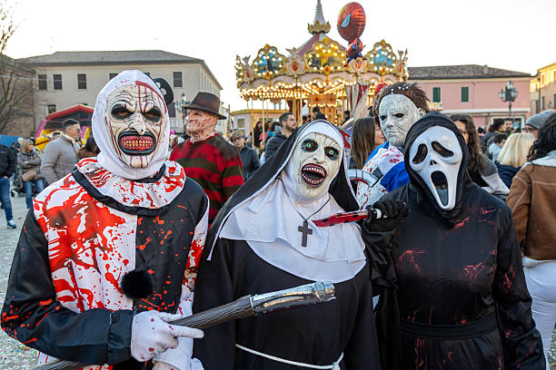 Piove di Sacco, Padua, Italy - Mar 16th, 2025: Carnival parade with people in scary horror costumes, including Freddy Krueger, Michael Myers, Ghostface, and The Nun