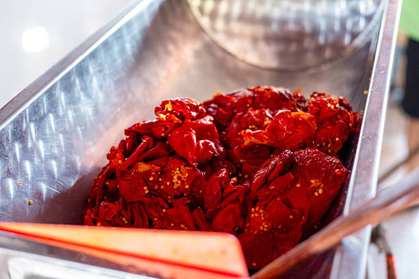Red hot chili pepper. Making red hot chili pepper mash in a grinder