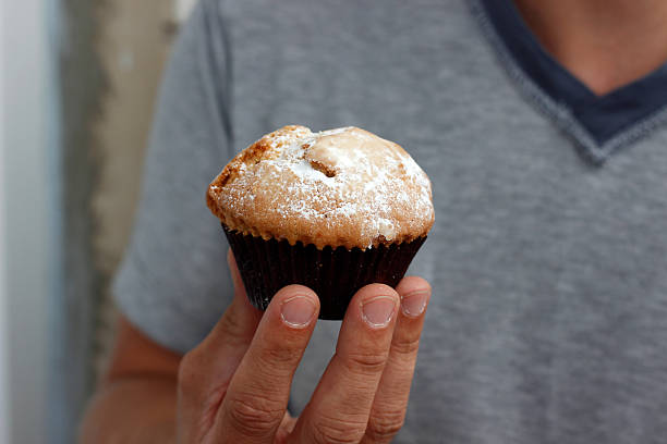istock cupcake in hand, sweet cupcake in palms, nutrition concept 2212930238