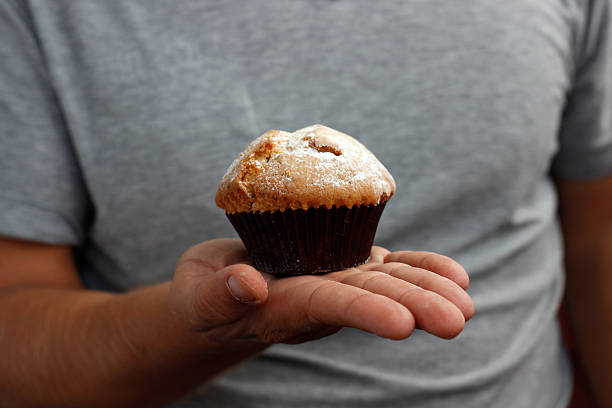 istock cupcake in hand, sweet cupcake in palms, nutrition concept 2212930243