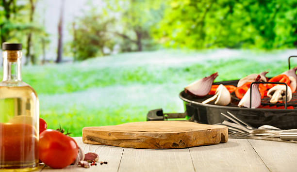 istock Barbecue Setup in Rustic Garden with Vegetables and Grill – Summer Picnic Concept. 2212932077