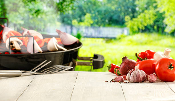 istock Barbecue Setup in Rustic Garden with Vegetables and Grill – Summer Picnic Concept. 2212932139