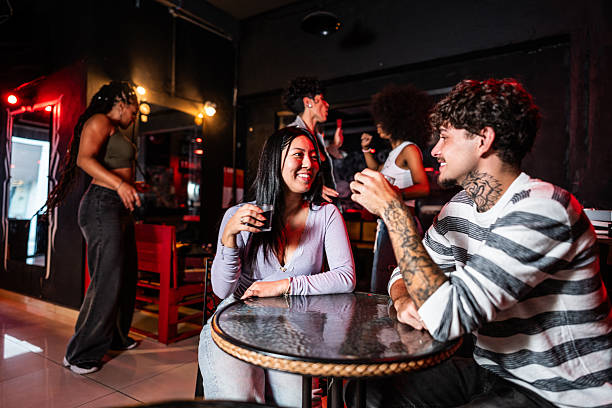 istock Young couple talking and drinking soda at pub 2212934317
