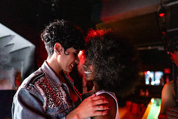 istock Lesbian couple dancing at pub 2212934534