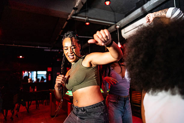 istock Young woman dancing at pub 2212935079