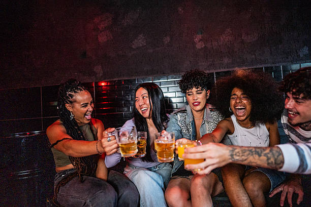 istock Friends talking and toasting beer at pub 2212935180