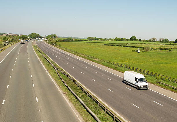 istock Small, White Works van on UK Road Heading South. 2212936755