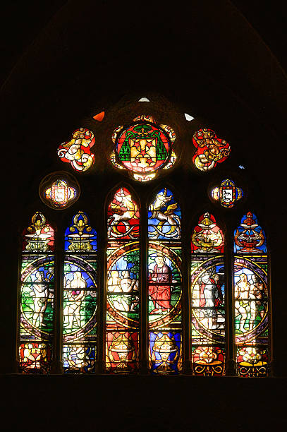 A stained glass window with a religious scene within notre dame cathedral in montreal canada.