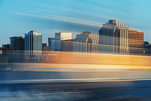 The blur of a public transportation ferry crosses Halifax harbour.