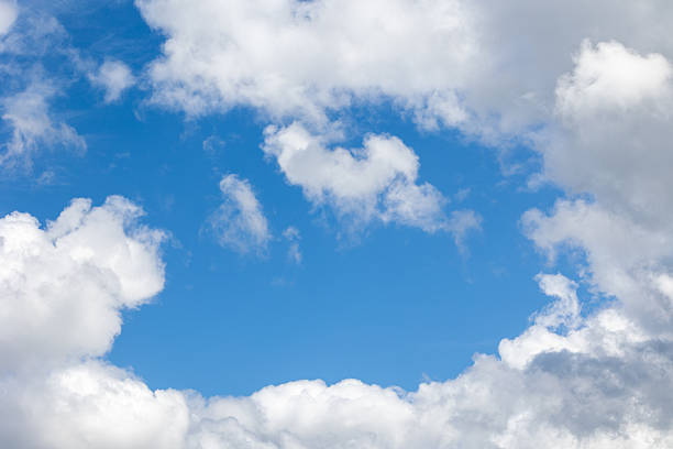 White clouds are floating on a bright blue sky, creating a serene and peaceful atmosphere