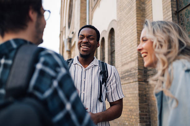 istock University students chatting and laughing together on campus 2212940213