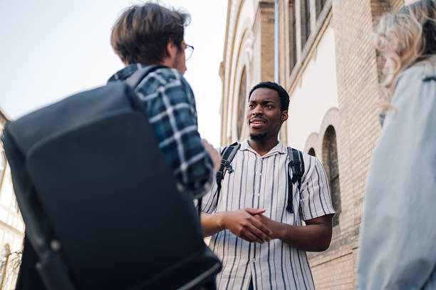 istock Students meeting and talking together outdoors 2212940217