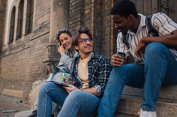 istock University students chatting and studying on stairs 2212940234