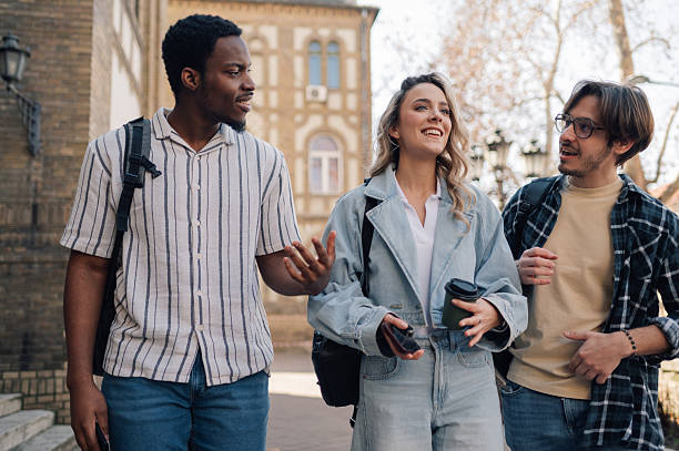 istock University students walking and talking together on campus 2212940253