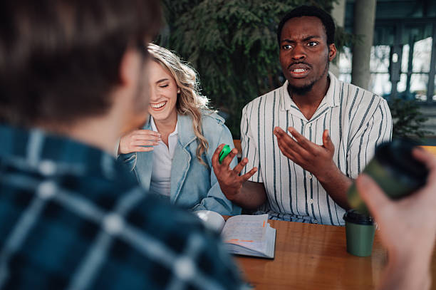 istock Young students having a lively discussion at campus cafe 2212940276
