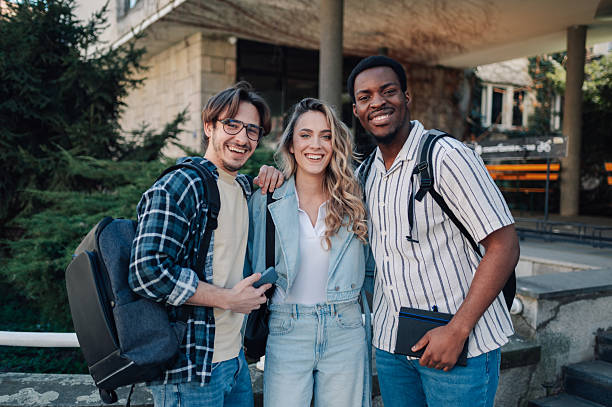 istock Cheerful multi-ethnic students smiling outside university building 2212940330