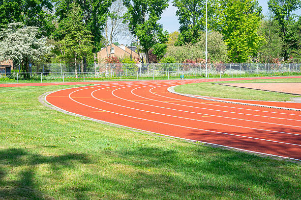 istock Curve of an empty running track on a sunny day 2212943751
