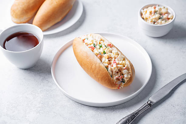 Imitatiom crab meat mayonnaise salad sandwich in a plate on a white background stock photo