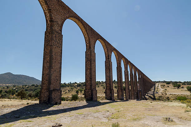 istock Father tembleque aqueduct stretching across mexican landscape 2212949991