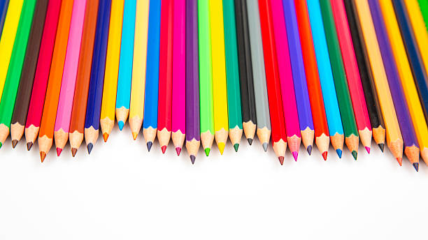 istock Sharpened colored pencils in a variety of hues lined up on a white backdrop. Suitable for artistic tools, school essentials, or creative project stock photos. 2212950550