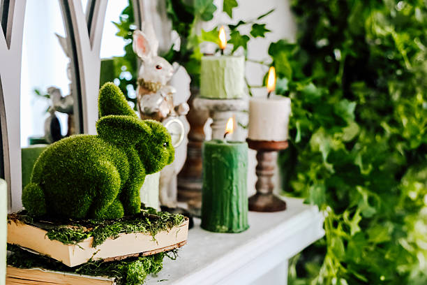 istock Decorative green bunny among candles and greenery in a cozy indoor setting 2212952937