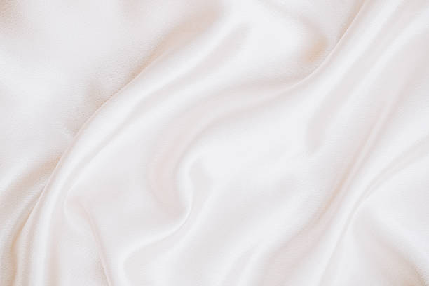 istock Soft white fabric draped gracefully on a surface for textile design inspiration 2212952938