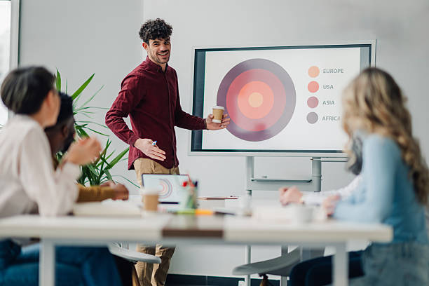 istock Young manager presenting marketing data to his colleagues during a meeting 2212957123