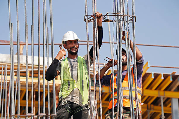 Dubai, United Arab Emirates - October 26, 2024 men working at construction field in summer season in gulf countries