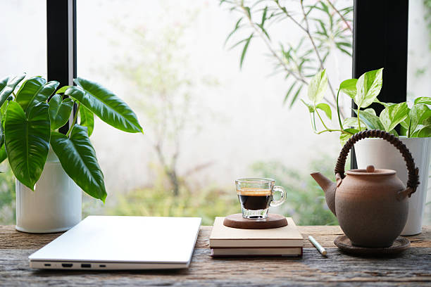 istock Coffee glass cup and folded laptop, cozy indoor workspace 2212958207