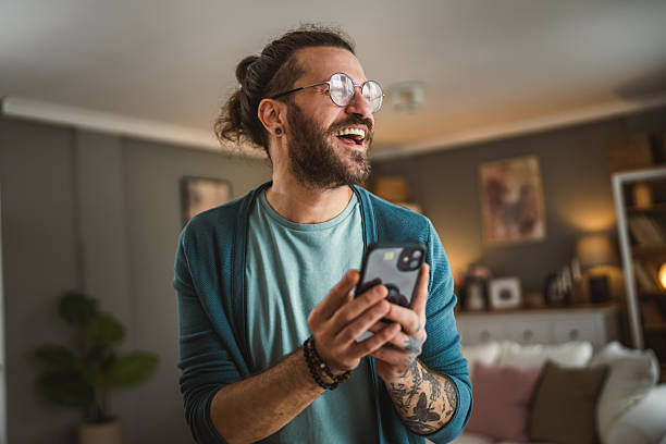 istock man with eyeglasses write message or browse internet hold mobile phone 2212958257
