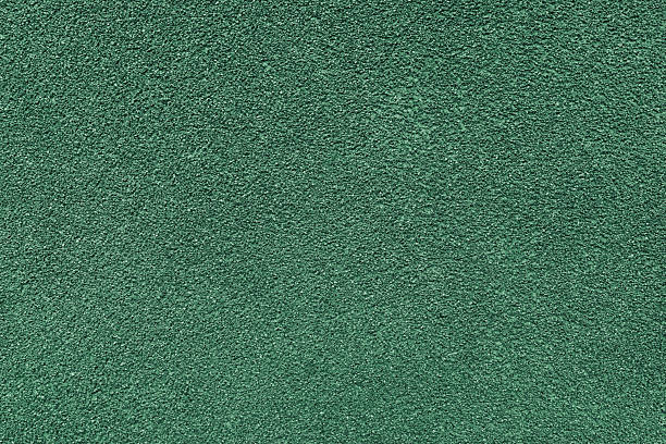 istock Grainy texture of green colored asphalt, plaster, cement, plastic close up, macro background 2212964337